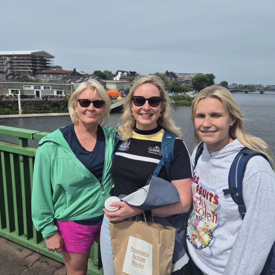 Three club members on a bridge over the Shannon at the Thomond Swim, Limerick