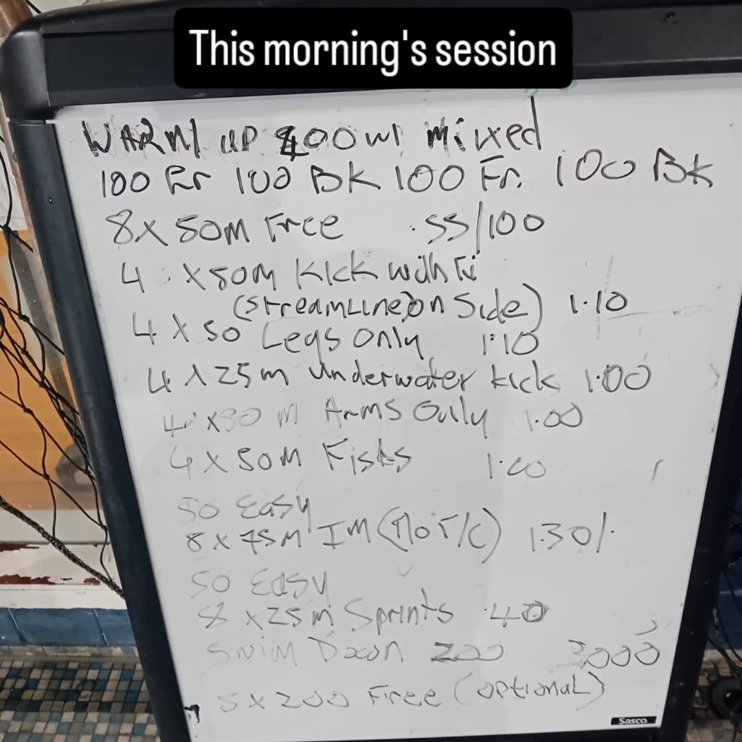 Whiteboard on the pool deck with the morning's training set written out